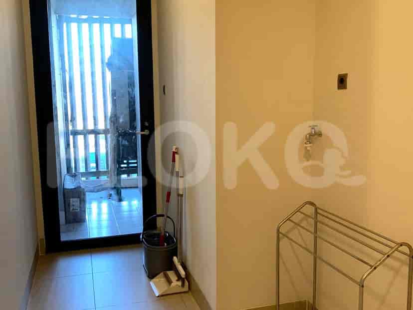 Laundry room with an open door and clothes rack.