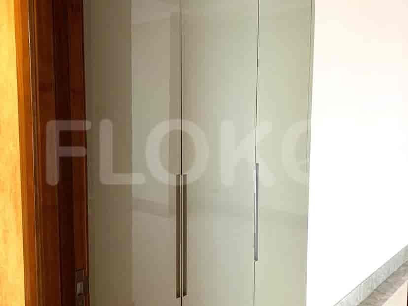 Bedroom with a closet and wooden door.