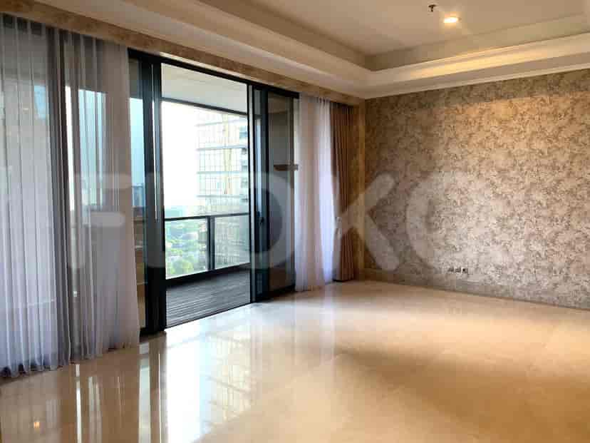 Spacious living room with large windows, sheer curtains, and a textured accent wall.