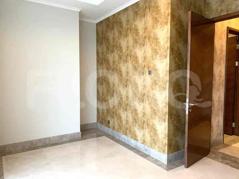 Bedroom with a textured accent wall and neutral-colored walls.