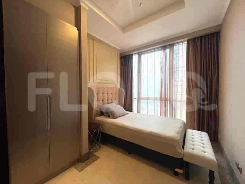 A well-appointed bedroom with a bed, bench, and closet.