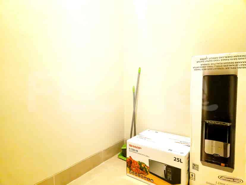 Corner of a room with a microwave and appliances.