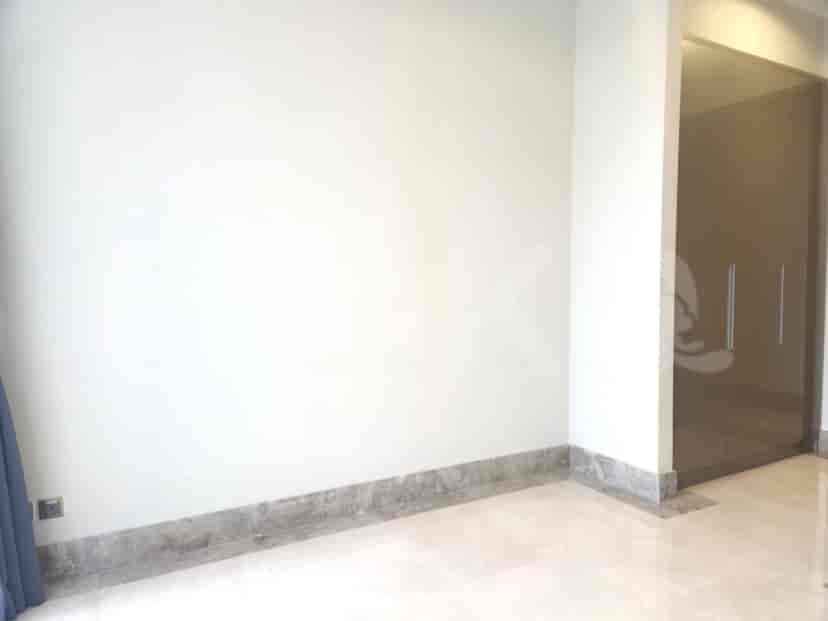 Hallway with white walls and beige trim.