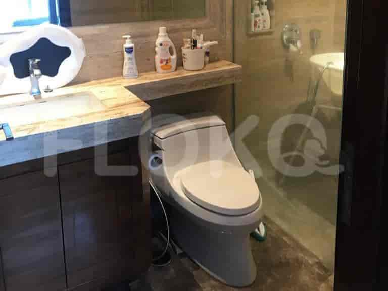 A bathroom with a sink, toilet and shower area.