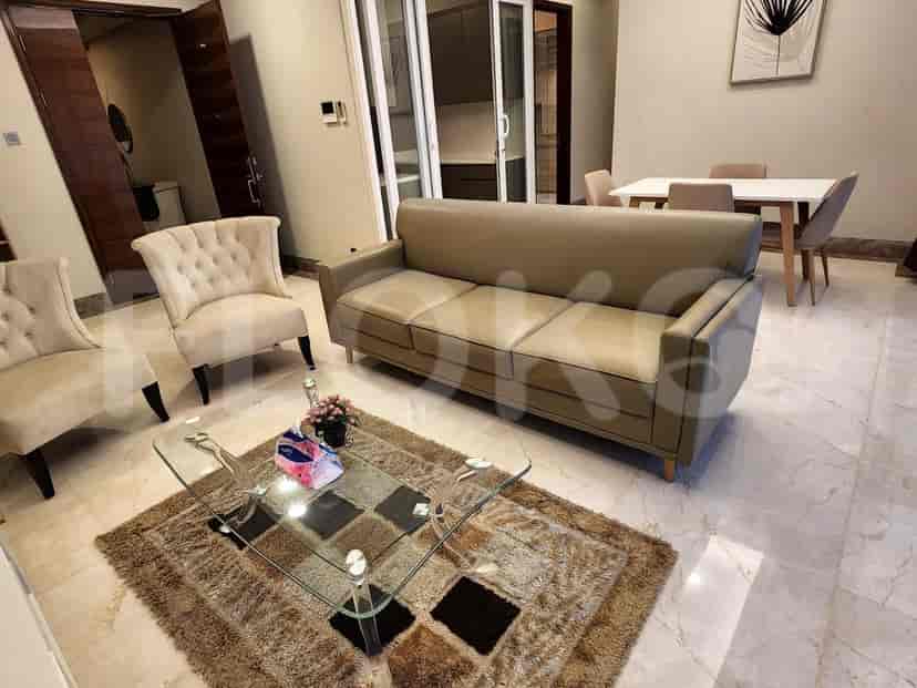 Living room with a sofa, armchairs, and glass coffee table.