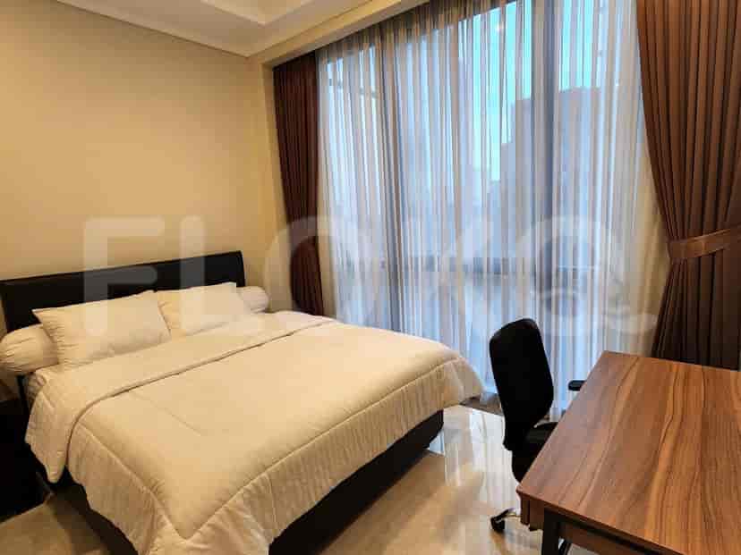 Bedroom with a vanity, bed, and window.