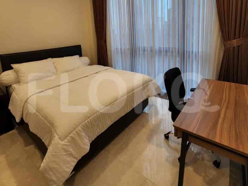 Bedroom with a bed, a desk and a large window