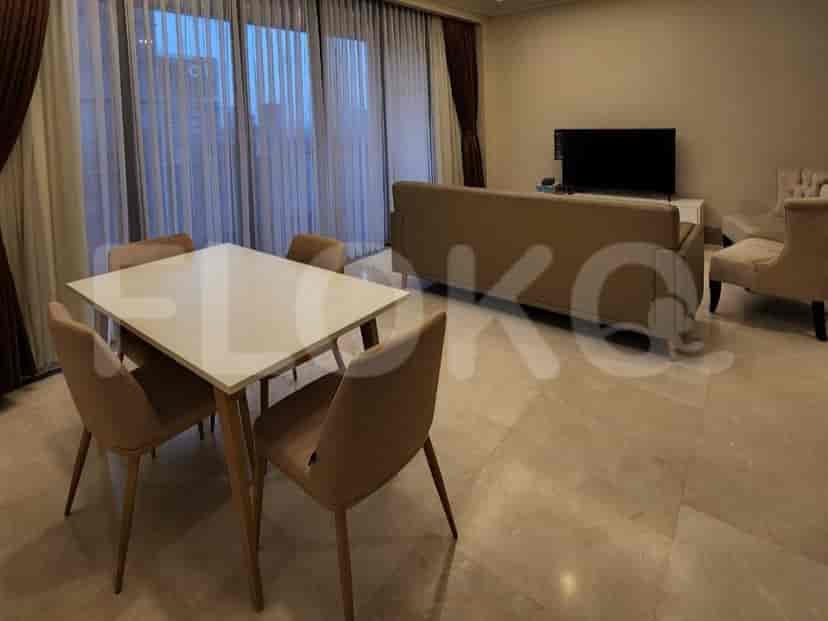 Living area with dining area, sofa, and TV.
