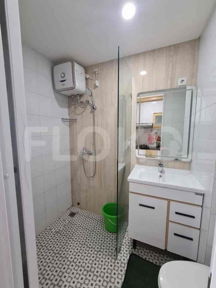 A modern bathroom with a shower, sink, and mirror.