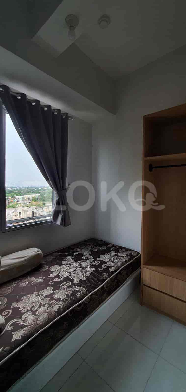 Small bedroom with a bed and view out the window.