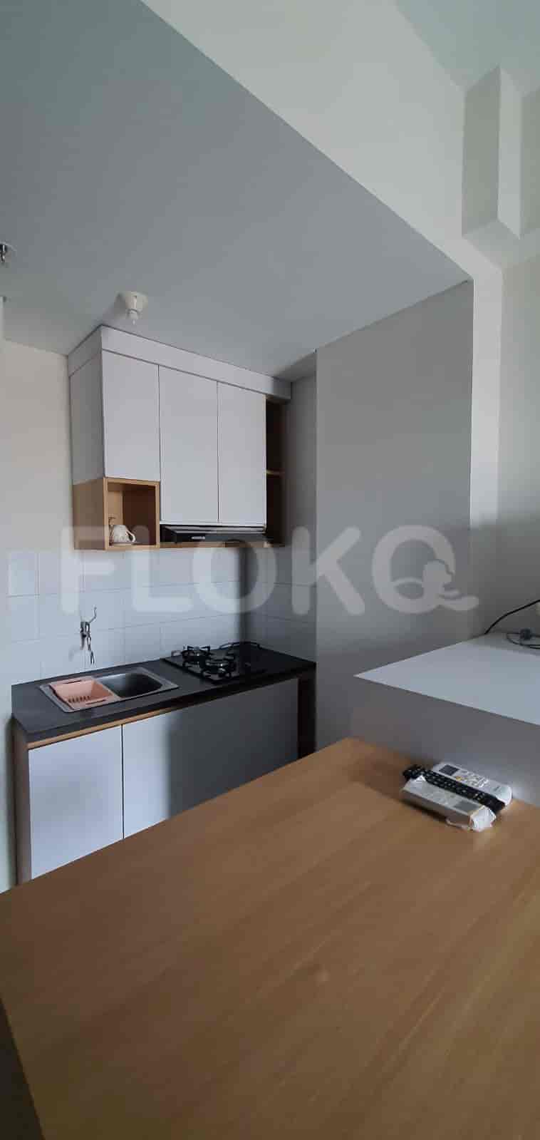Kitchen area with wooden table and cabinets.