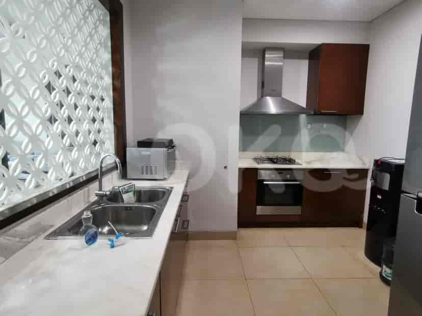 A modern kitchen with stainless steel appliances and a window.