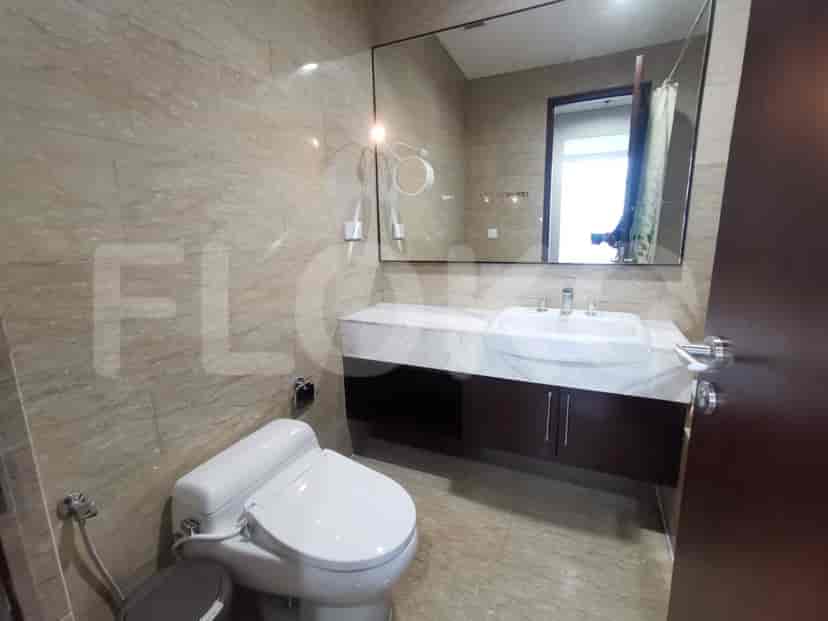 A modern bathroom with a sink, toilet, and mirror.