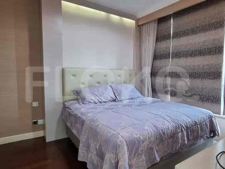 A bedroom with a bed and a window.
