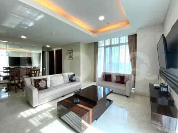 Elegant living room showcasing two sofas, a coffee table, and a mounted TV.