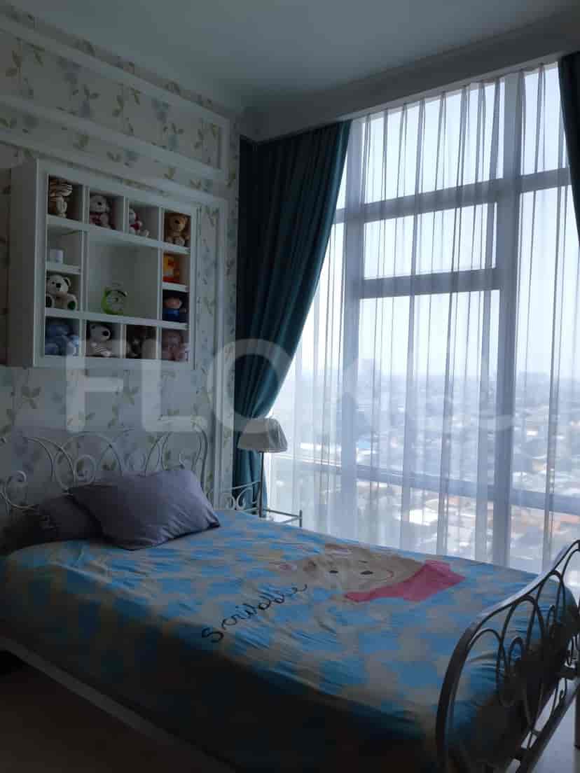 Bedroom with a bed, large window, and children's decor.
