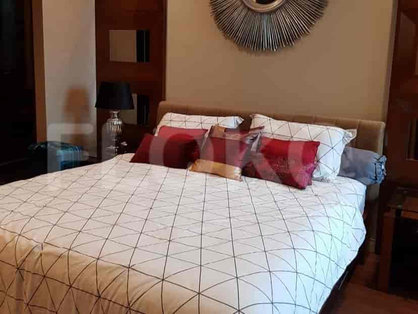 Bedroom featuring a bed, decorative pillows, and side tables.