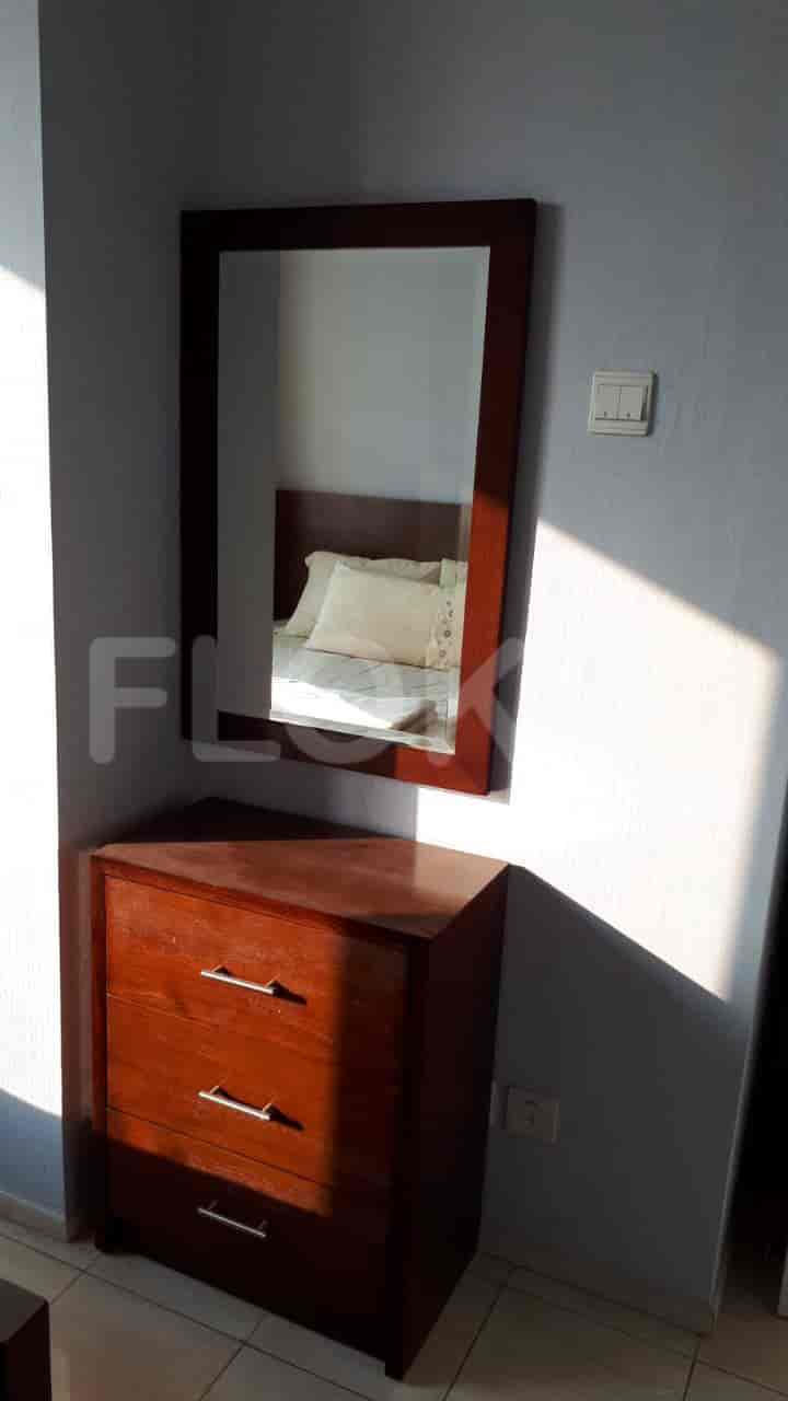 Bedroom with a dresser and mirror.