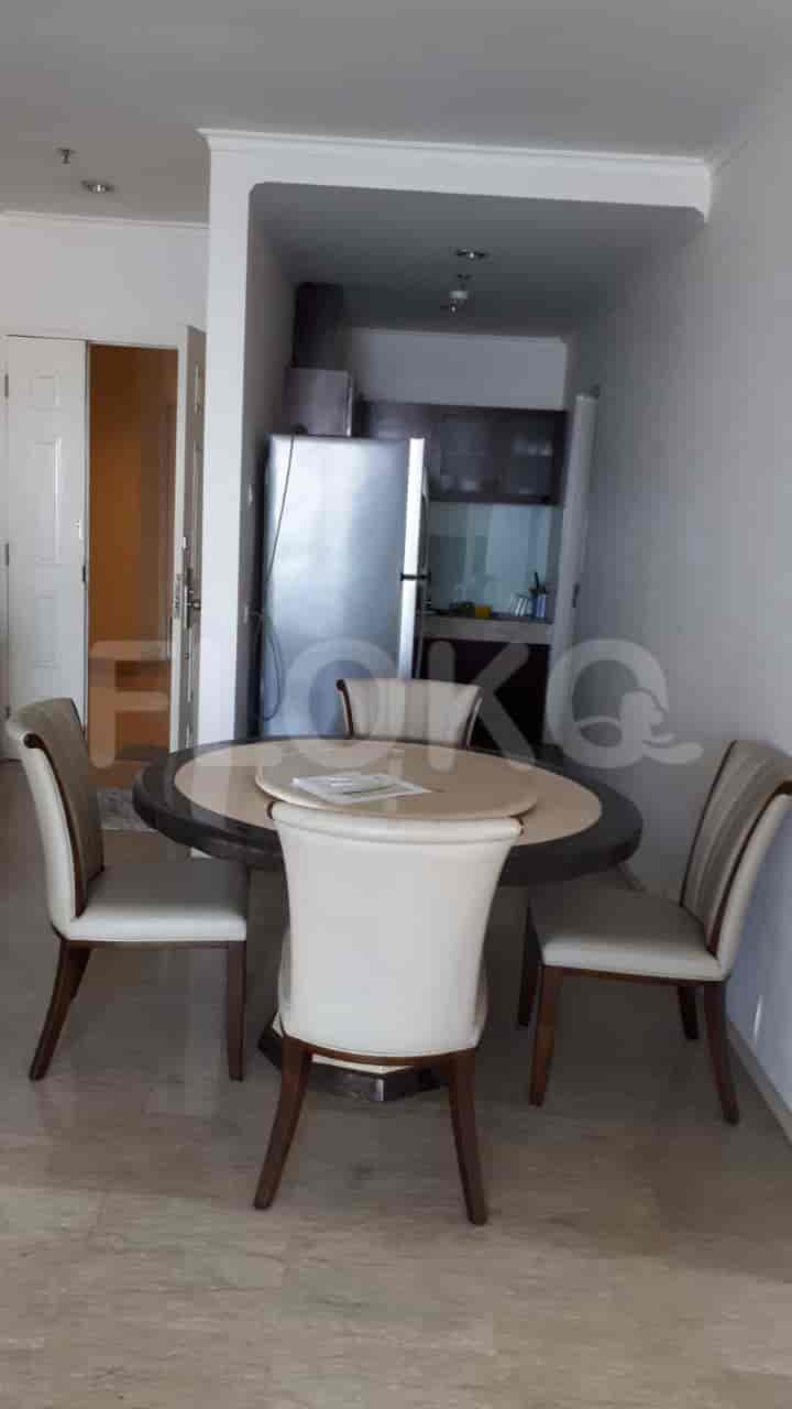 Dining area with round table and four chairs.