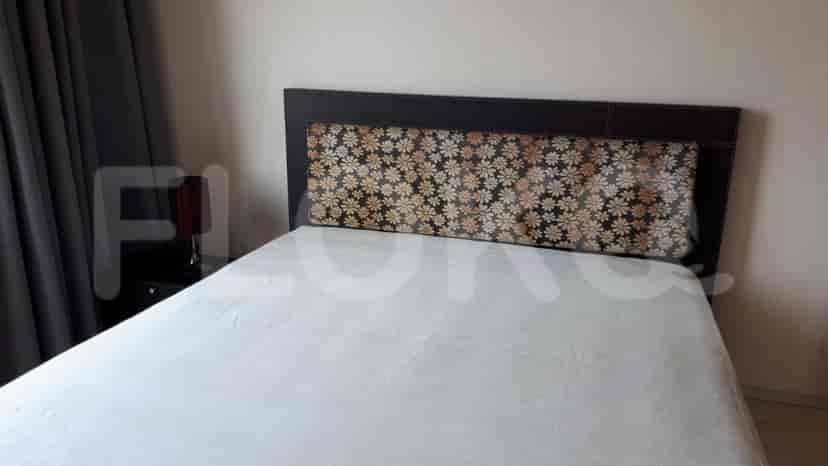 Bedroom with a bed, nightstand, and wall art.