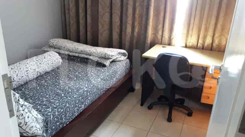 A bedroom with a bed, desk, and office chair.