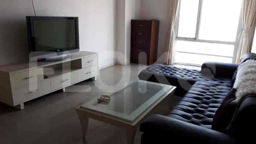 A living room with a TV and sofa.