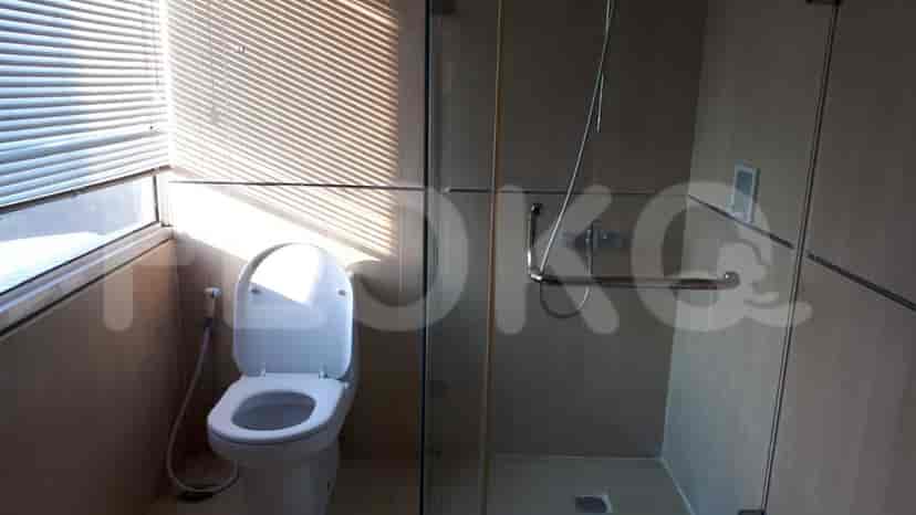 Bathroom with a shower, toilet, and window view.