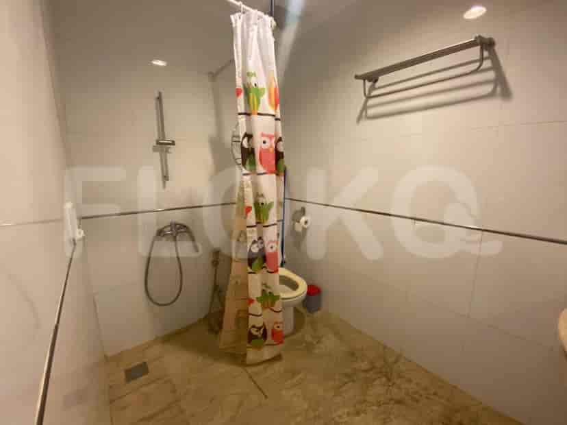 A bathroom with a shower and a toilet.