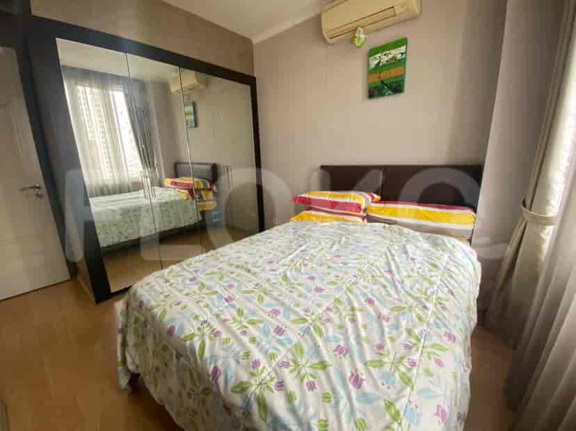 Bedroom with a large bed, closet, and air conditioning.