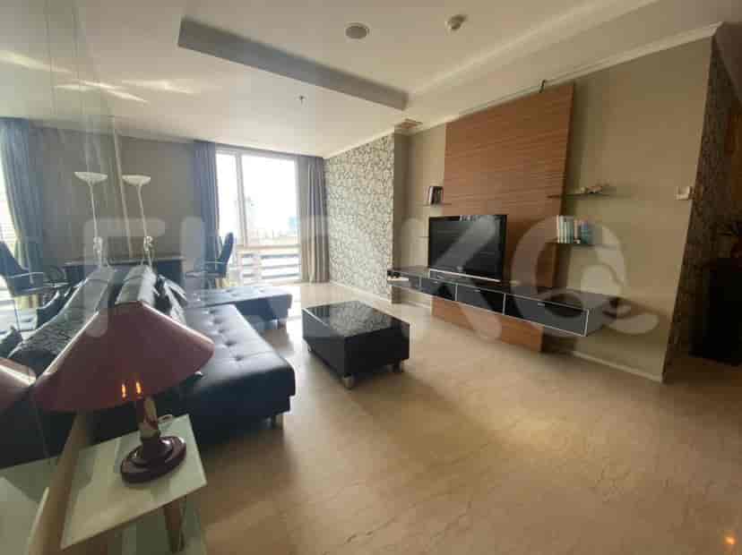 A living room with a sofa, a coffee table, and a TV unit.