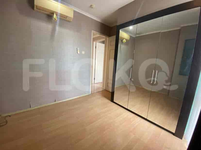 An empty bedroom with a mirrored closet.