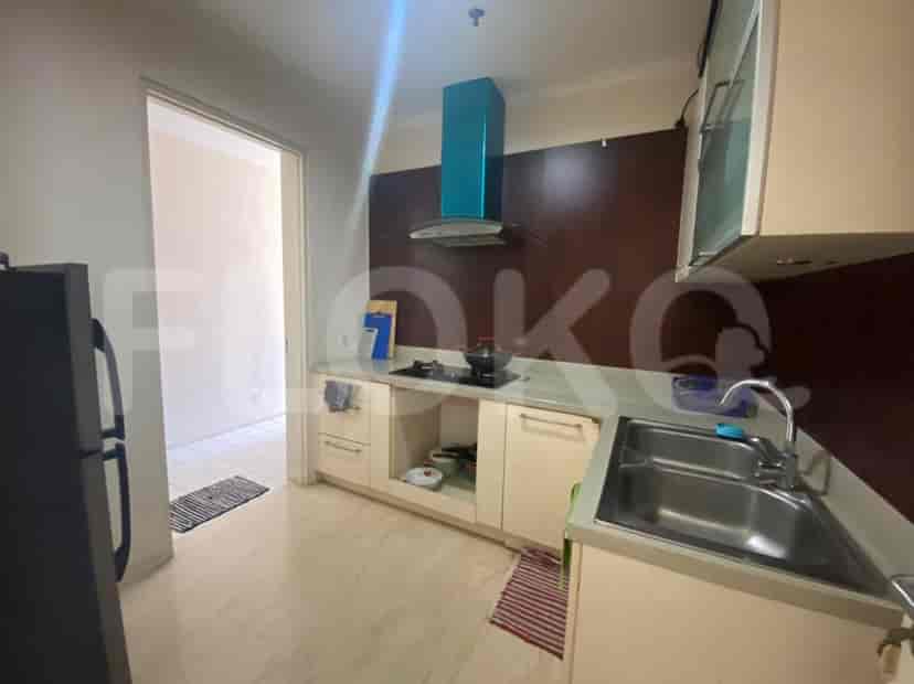 Another view of the kitchen, showing the gas stove and the sink.