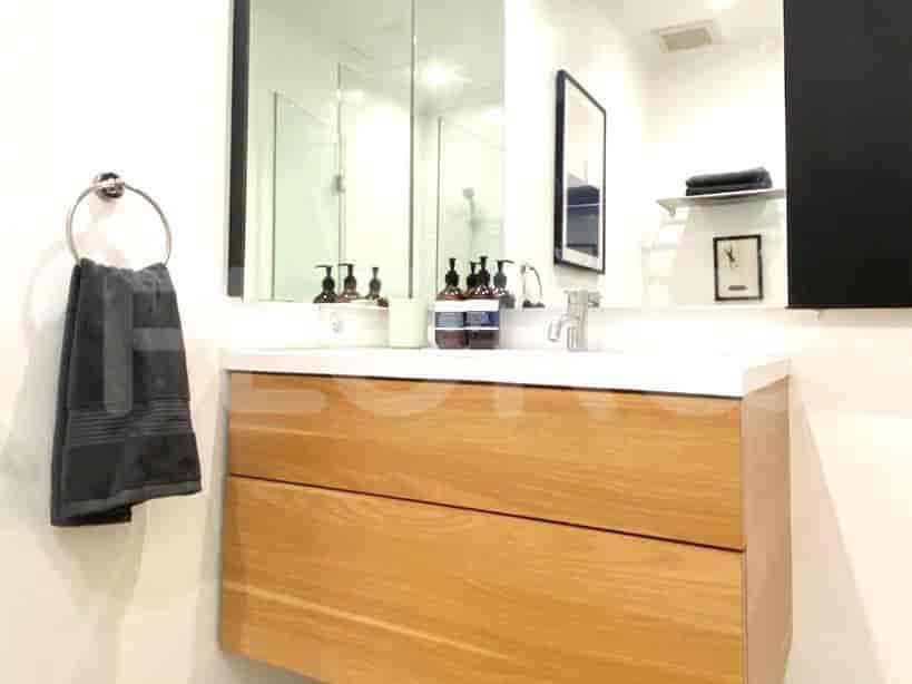 Bathroom with a vanity, mirror and towel rack.
