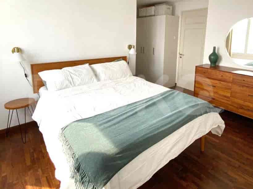 Cozy bedroom with a double bed, bedside table, and wall sconces.