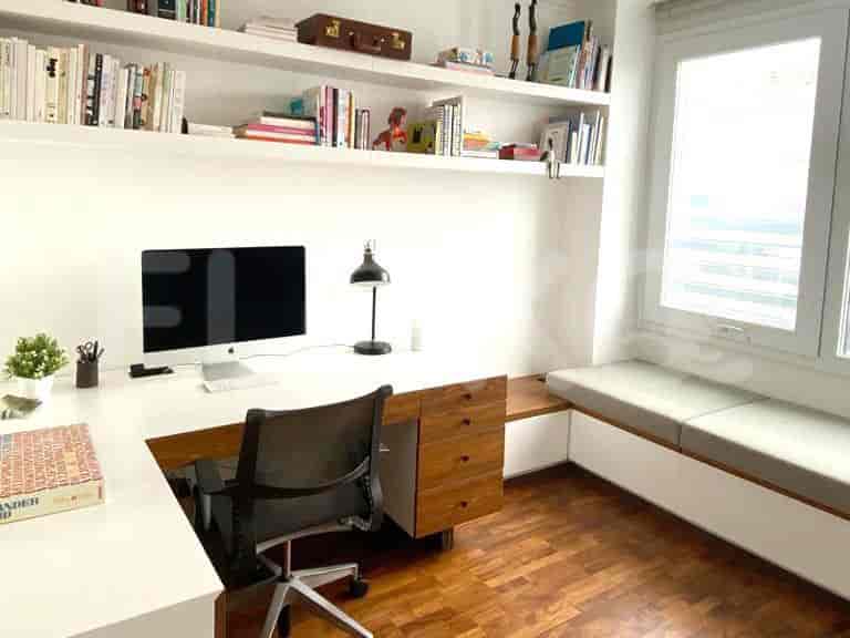 Home office with a desk, computer, and shelving.
