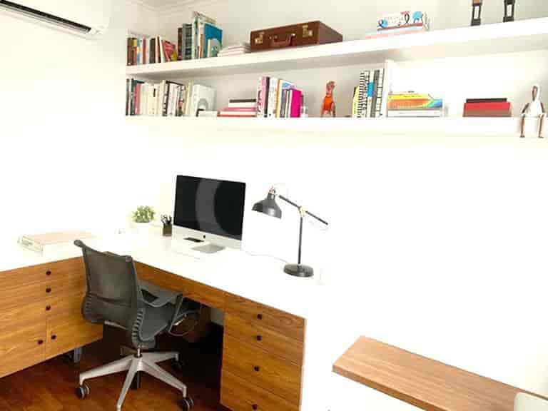 Home office with a desk, computer, and shelving.