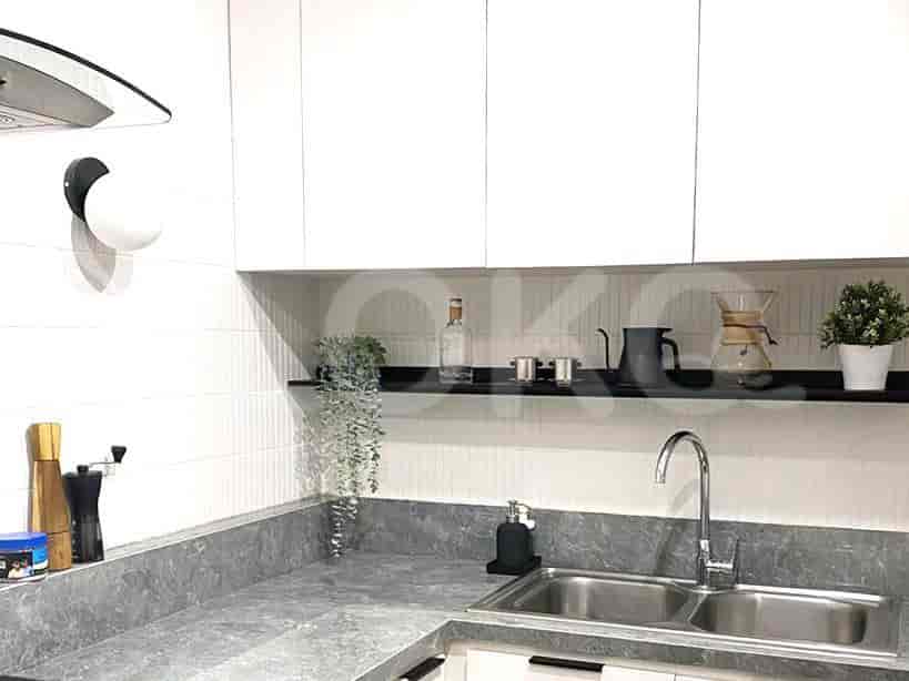 Kitchen with white cabinets, gray countertops, and a stainless steel sink.
