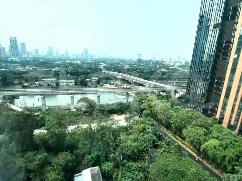 A view of a river and bridge, with city buildings in the background.