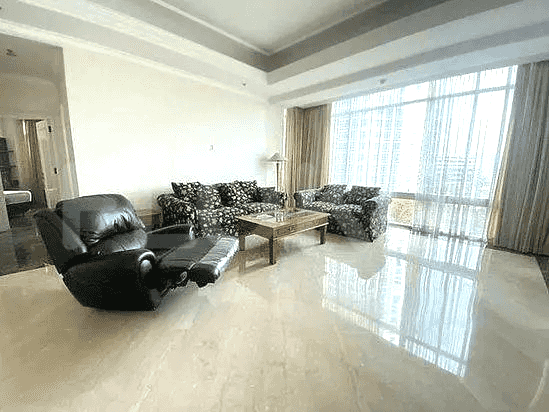 Living room with floral print sofas and recliner, coffee table, and large windows with curtains.