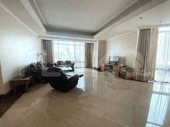 Spacious living room with sofas, TV cabinet, large windows.