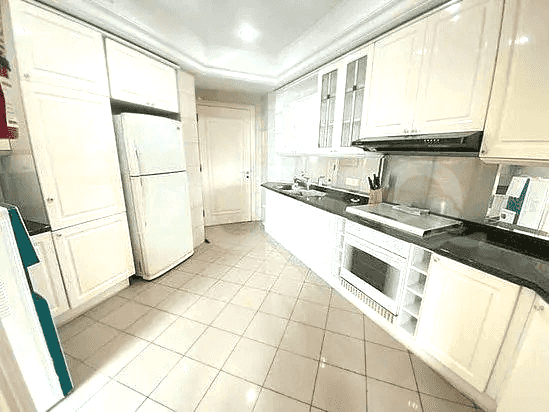 Modern kitchen with white cabinets and appliances.