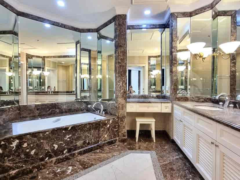 Spacious bathroom with a bathtub, double vanity, and luxurious marble finishes.