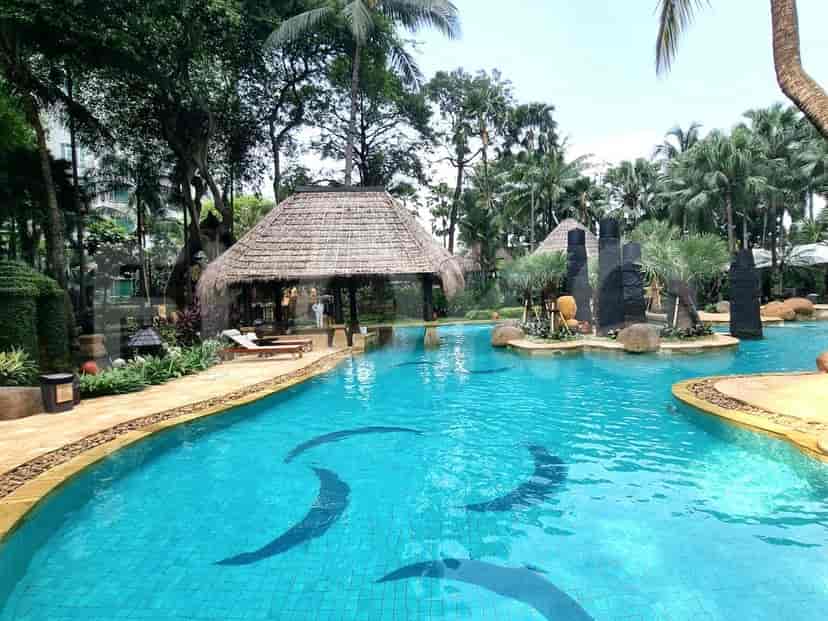 Inviting swimming pool with a swim up bar in a tropical environment.