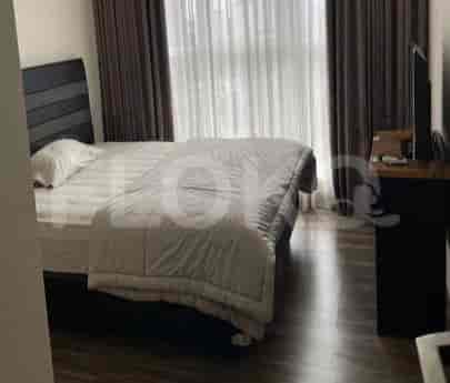 Another view of the bedroom with bed and curtains.
