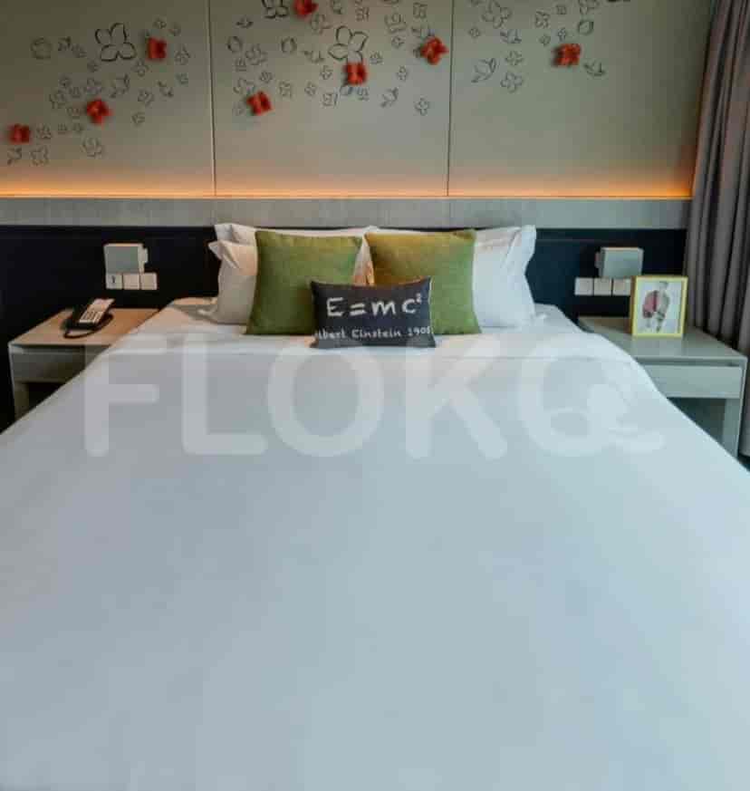 Bedroom with a bed, floral wall decor, and bedside tables.