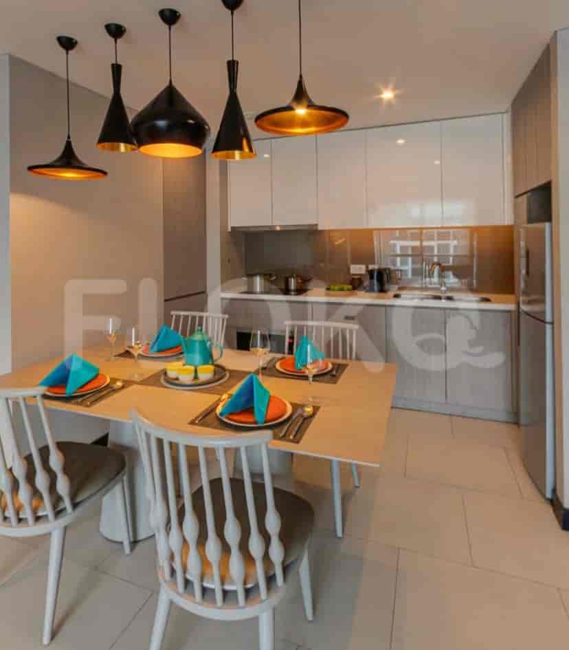 Dining area with a table, chairs, and pendant lights.