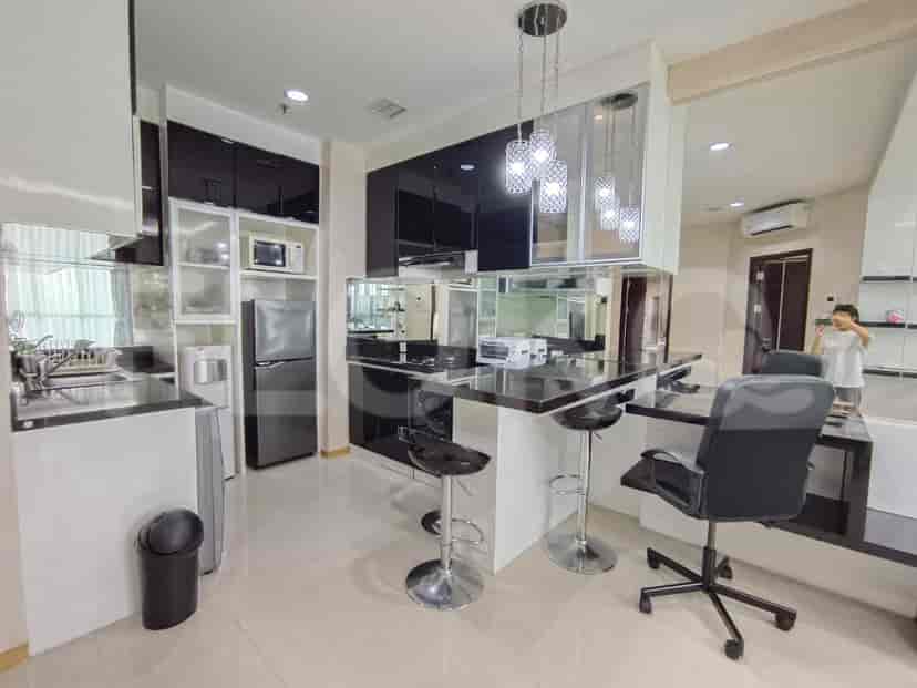 Modern kitchen with black cabinets, breakfast bar, and stainless steel appliances.