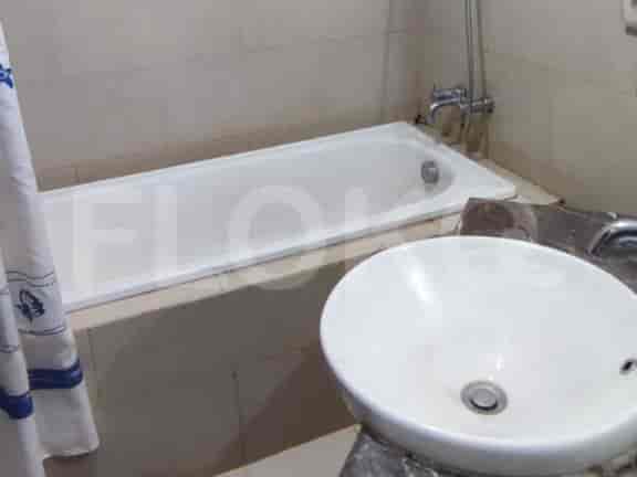 The bathroom features a bathtub, sink, and shower.