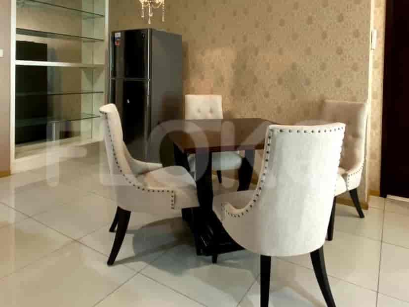 A dining area with a table and chairs.
