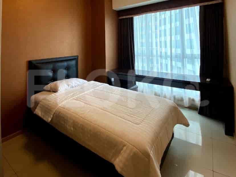 A guest bedroom with a bed and a desk.
